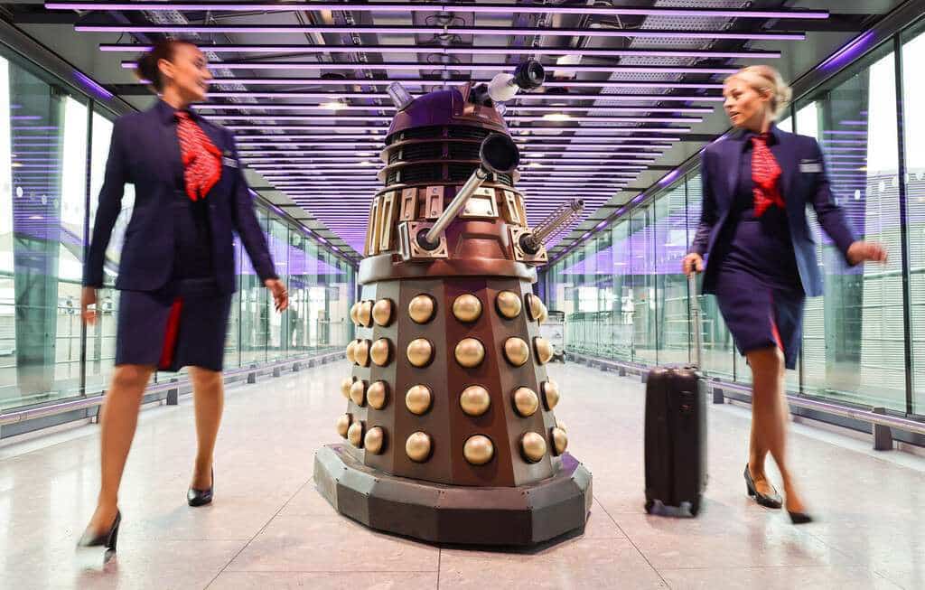 A Dalek with British Airways flight attendants.