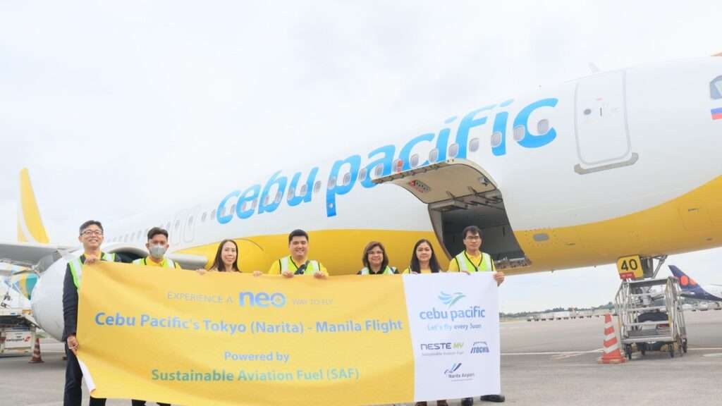 Cebu Pacific staff with a banner celebrating the first SAF powered flight from Japan to Manila.