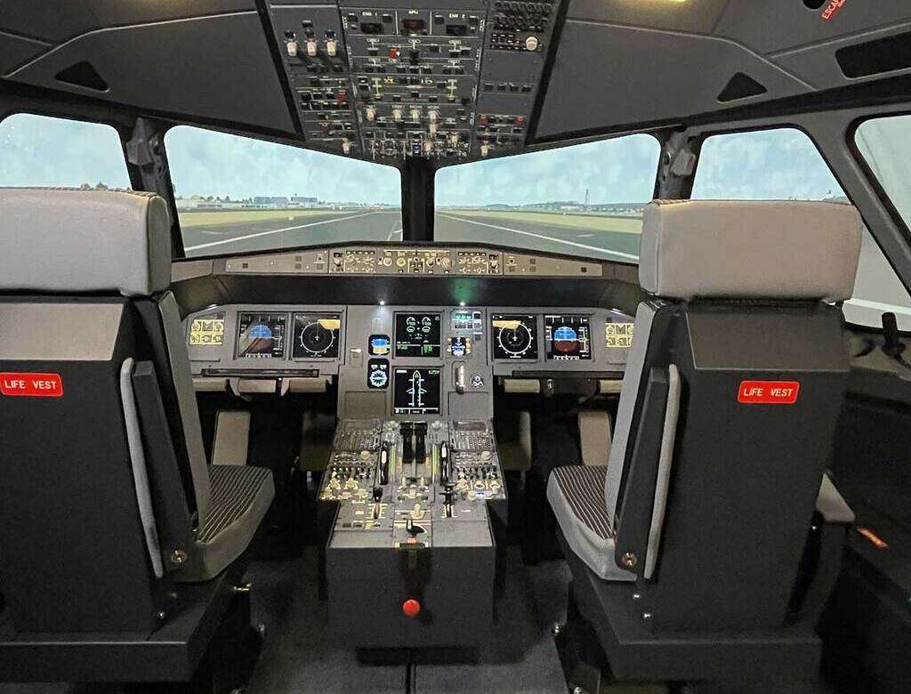 Interior of ELITE A320 FNPT II MCC flight simulator.