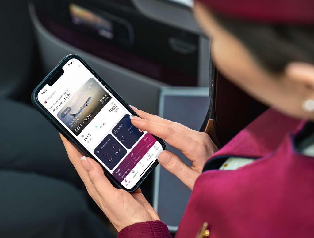 A Qatar Airways cabin crew member with phone app.