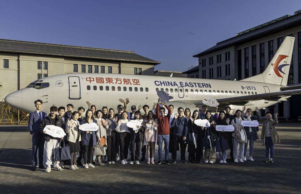 International students with a China Eastern Airlines jet at the R&D Center.