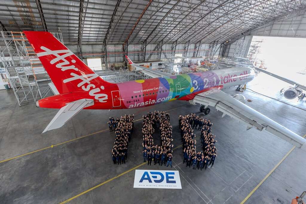 Asia Digital Engineering staff with an AirAsia aircraft in the hangar.