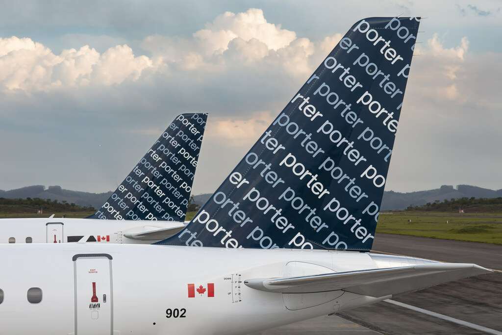 The tailplanes of two Porter Airlines aircraft parked together.