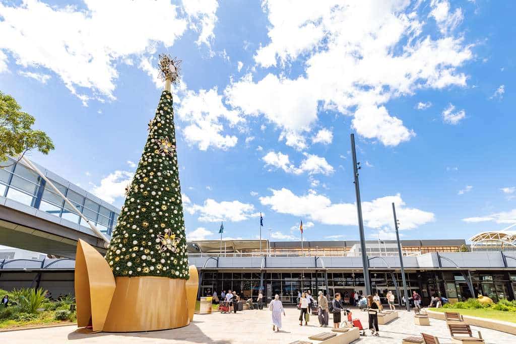 Exterior of Sydney Airport with Christmas tree.