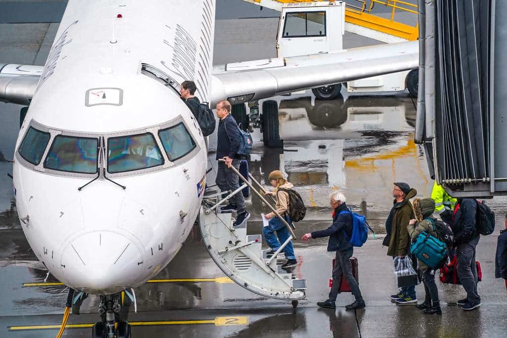 Passengers board an aircraft at a Norwegian airport.