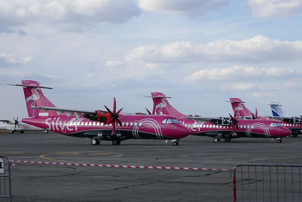 A line of parked Silver Airways aircraft.