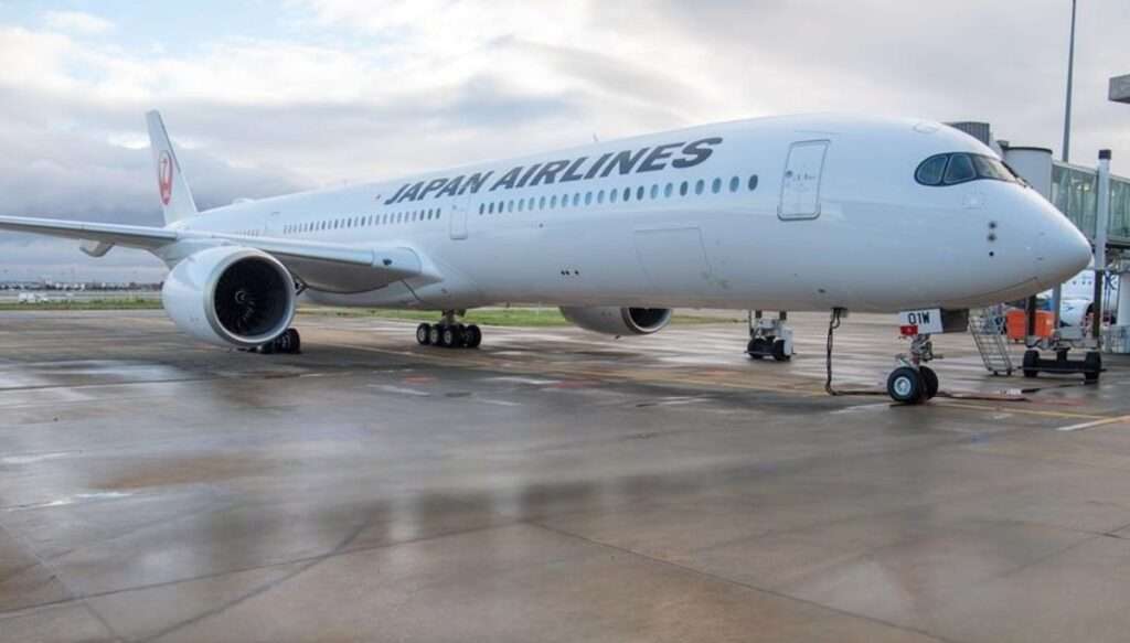 A Japan Airlines Airbus A350-1000 parked at the gate.