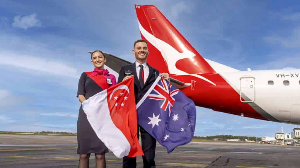 Qantas staff with Australian and Singaporean flags