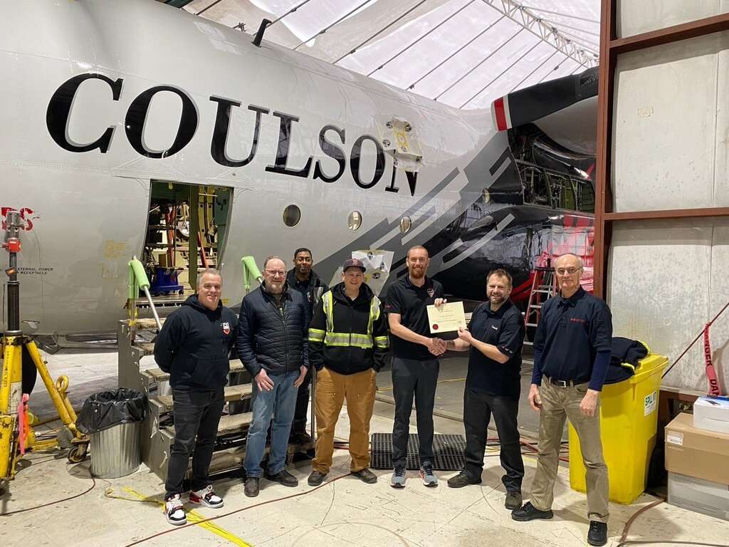 Coulson Aviation staff with aircraft in hangar.