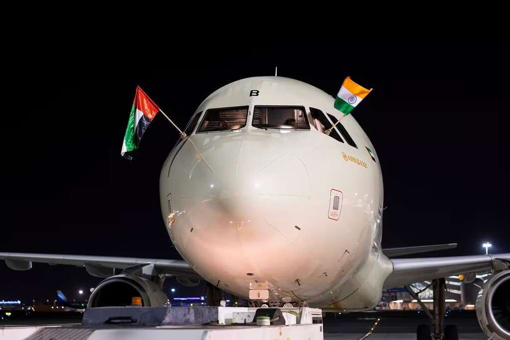 An Etihad Airways jet with UAE and Indian flags.