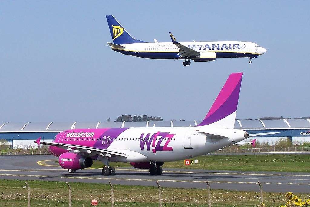A Wizz Air aircraft waits for a Ryanair aircraft to land.