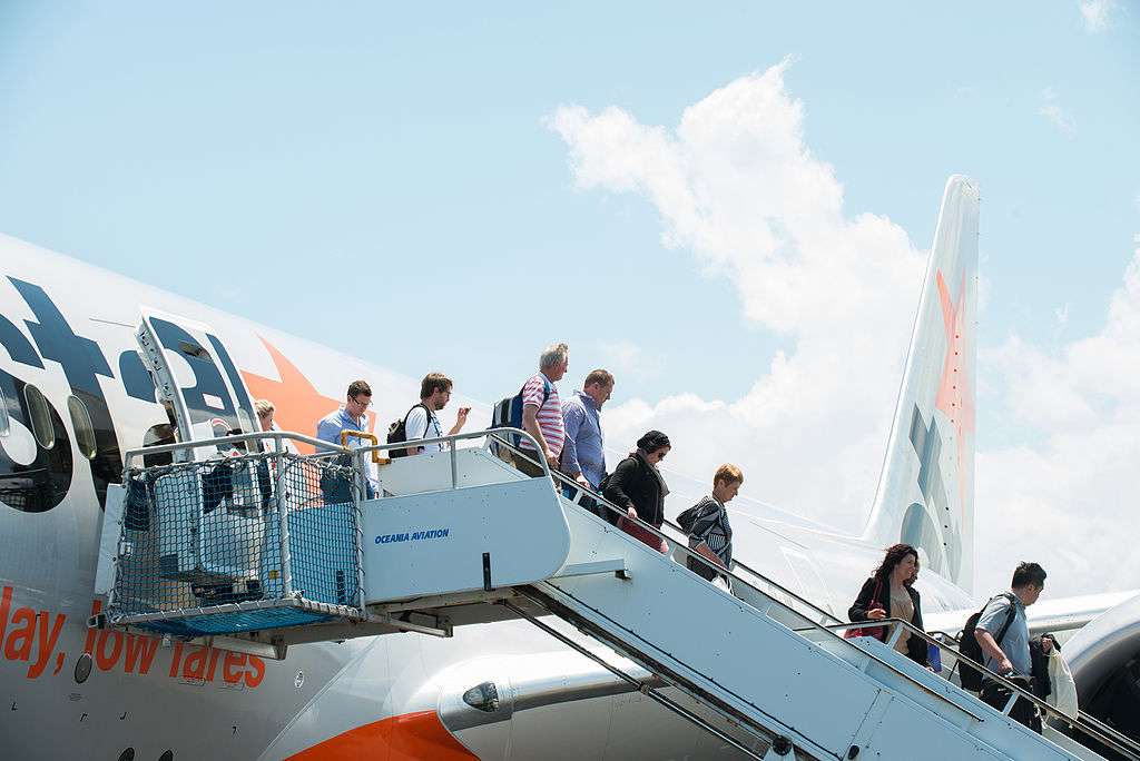 Passengers disembark an aircraft at Queensland Gold Coast Airport.