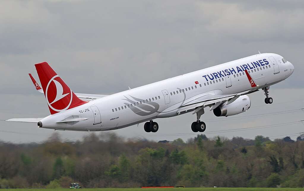 A Turkish Airlines A321 climbs out after takeoff.