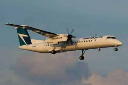 A WestJet Encore Dash 8 turboprop aircraft approaches to land.