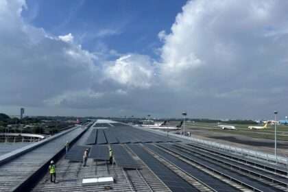 Workers install solar panels at Singapore Changi Airport