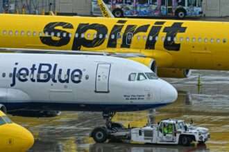 A JetBlue and a Spirit Airlines aircraft side by side.