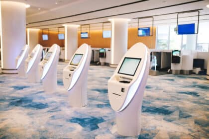 A line of automated check-in machines at an airport.