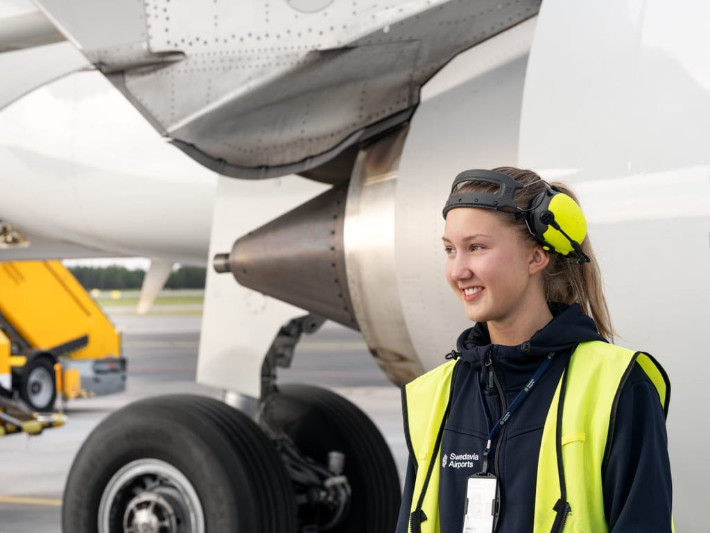 A Swedia ground worker alongside an aircraft.
