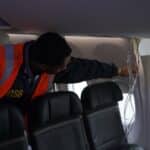 An NTSB investigator inspects a door plug on an Alaska Airlines jet.