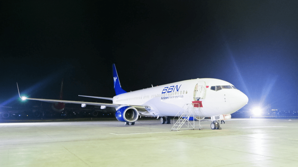 A BBN Airlines Indonesia Boeing parked on the tarmac at night.