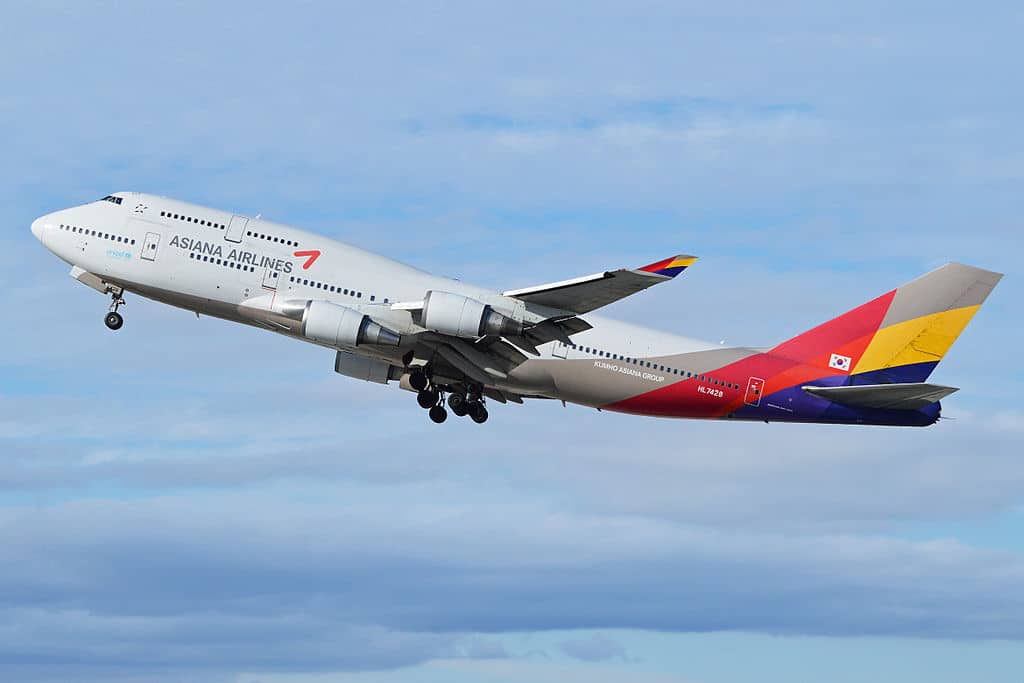 An Asiana Airlines Boeing 747 climbs after takeoff.