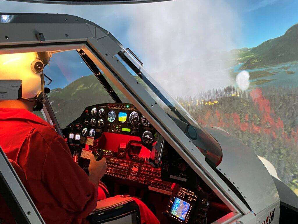 A pilot conducts aerial firefighting training in  Conair simulator
