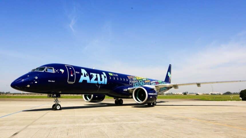 An Azul Embraer E195 parked on the tarmac.