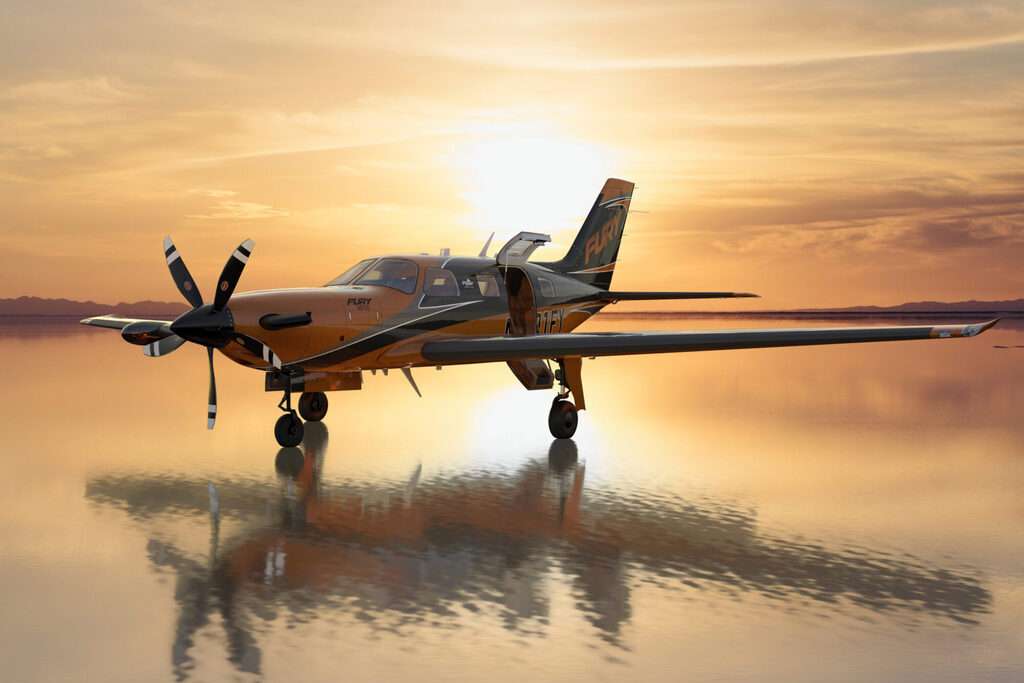 A Piper M700 Fury aircraft parked at sunset.