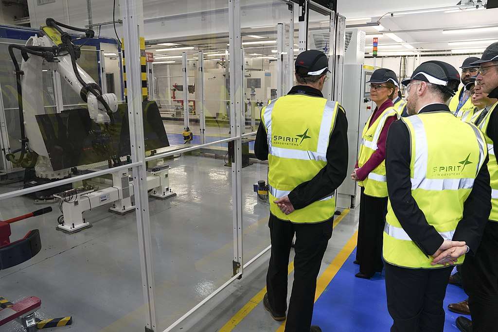 Officials tour a Spirit AeroSystems facility in Scotland.