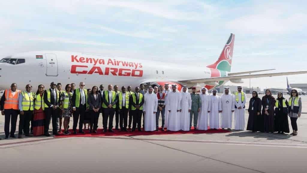 Airport and airline personnel stand with Kenya Airways Cargo aircraft at Sharjah Airport