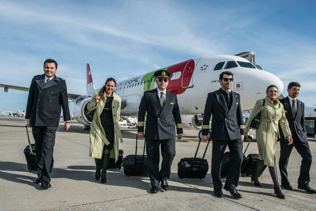 A TAP Air Portugal crew and aircraft on the tarmac.