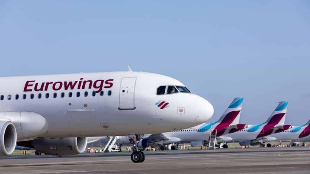 A line of Eurowings aircraft on the tarmac.