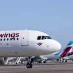 A line of Eurowings aircraft on the tarmac.