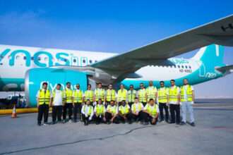 A group of 22 Saudi engineer candidates with a flynas aircraft.