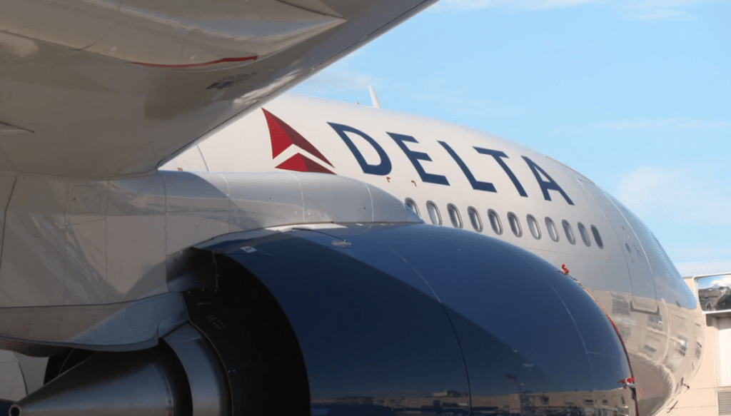 Close-up of the fuselage of a parked Delta Air Lines aircraft.