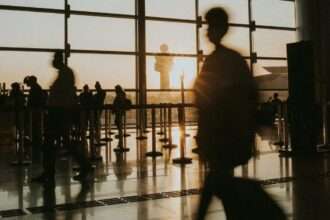 Passengers in an airport terminal at dusk