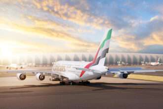 An Emirates A380 taxies as the sun rises.