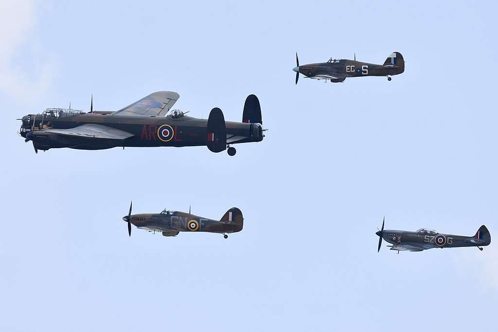 Battle of Britain Memorial Flight aircraft fly in formation.