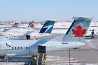 WestJet and Air Canada aircraft parked at a Canadian airport.