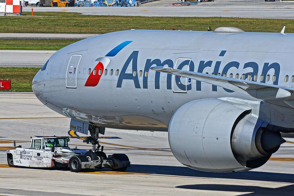 An American Airlines Boeing 777 under pushback at Miami