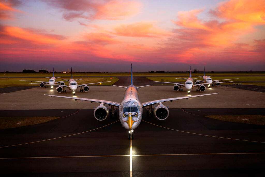 A group of Embraer E-Jets at dusk.