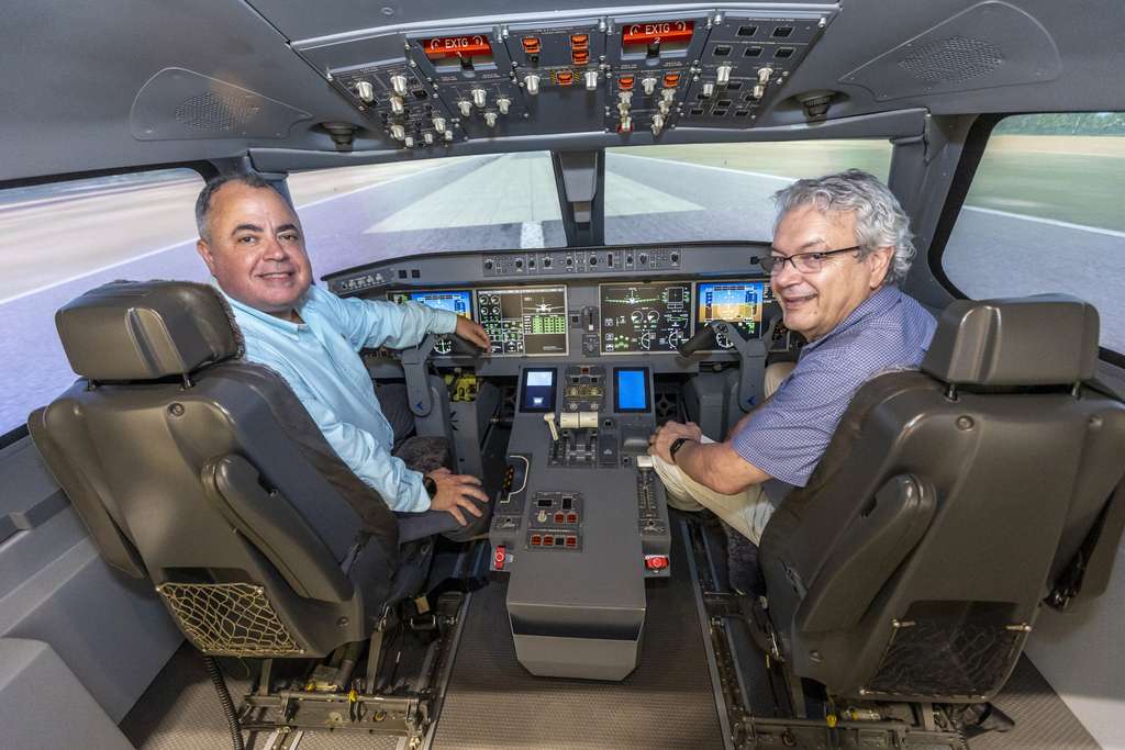 Two Brazilian scientists in the cockpit of an Embraer E-Jet