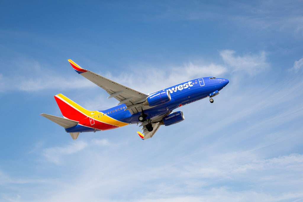 A Southwest Airlines flight climbs overhead.