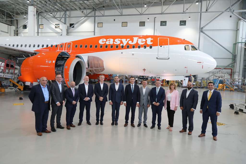 easyJet and SR Technics staff in the hangar with aircraft.