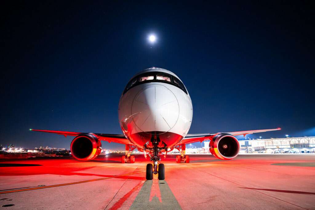 Frontal view of an Air Canada Boeing 777 at night.