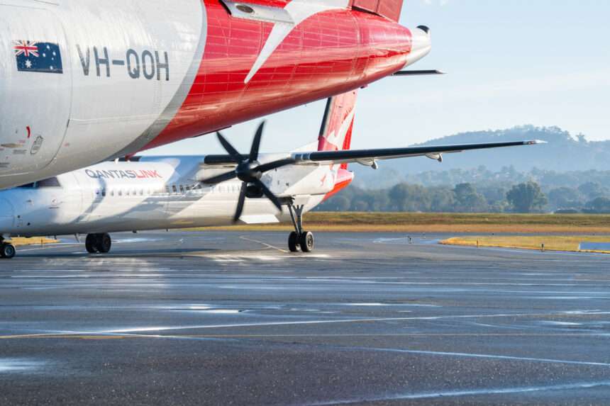 Two Qantas Qantaslink Dash 8 aircraft parked on the tarmac.
