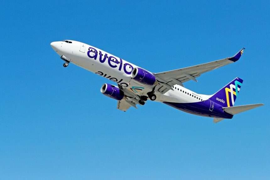 An Avelo Airlines 737 climbs overhead.