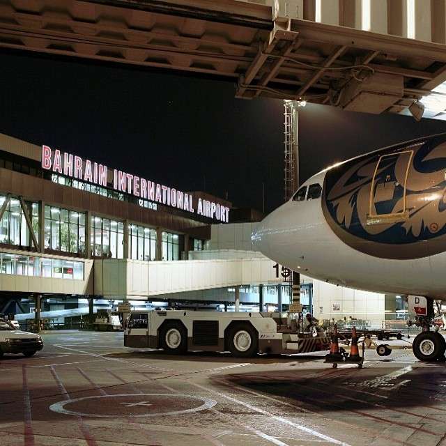 Bahrain International Airport apron area at night.