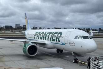 A Frontier Airlines aircraft at the terminal gate.