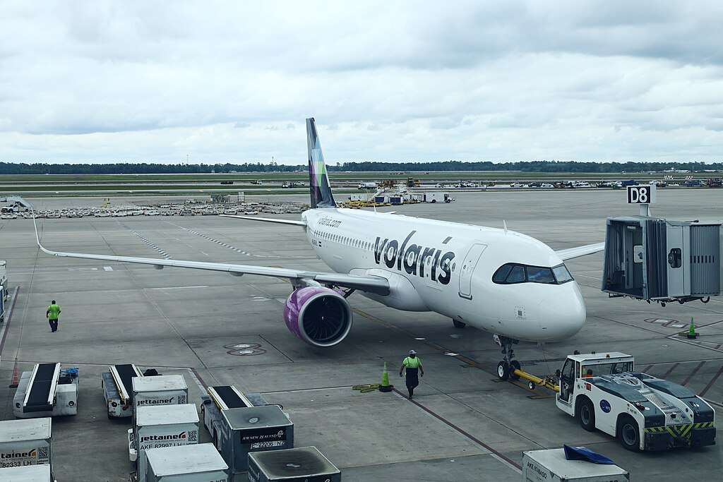 A Volaris Airbus parked at the terminal.